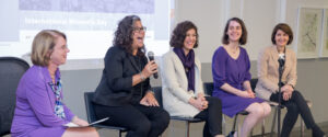Five women sitting on a panel.