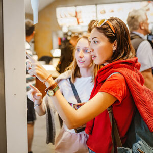 Women using a digital ordering device in a restaurant.