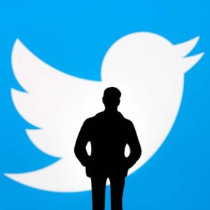 Man in front of twitter logo