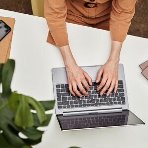 Close up of hands on a laptop.