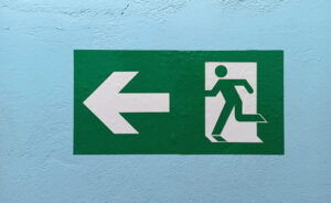 An exit sign posted on a wall.