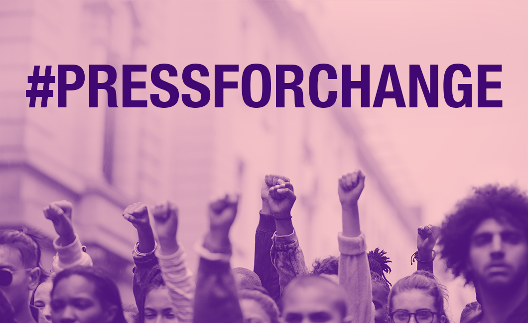 Protestors with their hands in the air and the text: #Pressforchange