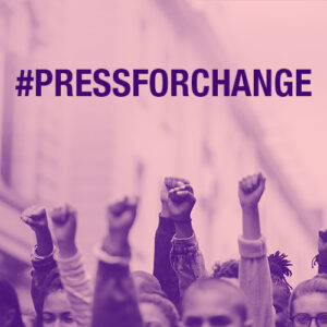 Protestors with their hands in the air and the text: #Pressforchange