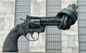 A statue of a gun with it's barrel tied in a knot.