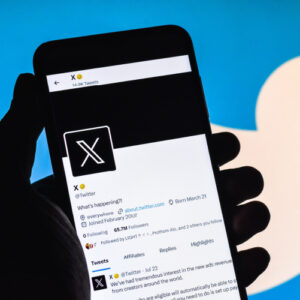 X app with Twitter bird in background