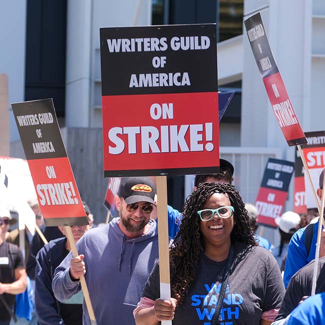 Hollywood writers' strike with diverse people holding picket signs