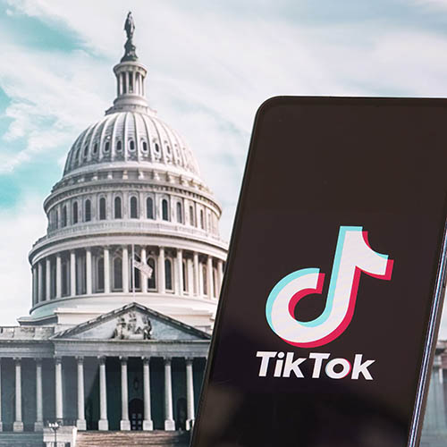 TikTok logo on a smartphone with the U.S. Capitol building in the background