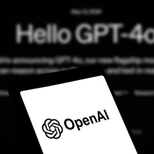 OpenAI open on a smart phone with the words "Hello GPT-4o" in the background behind the phone